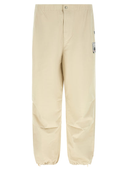 Activewear Pants by Maison Mihara Yasuhiro for men in cotton beige features an contemporary tapered-leg, athletic & wide with a long and , showcasing for a contemporary finish.