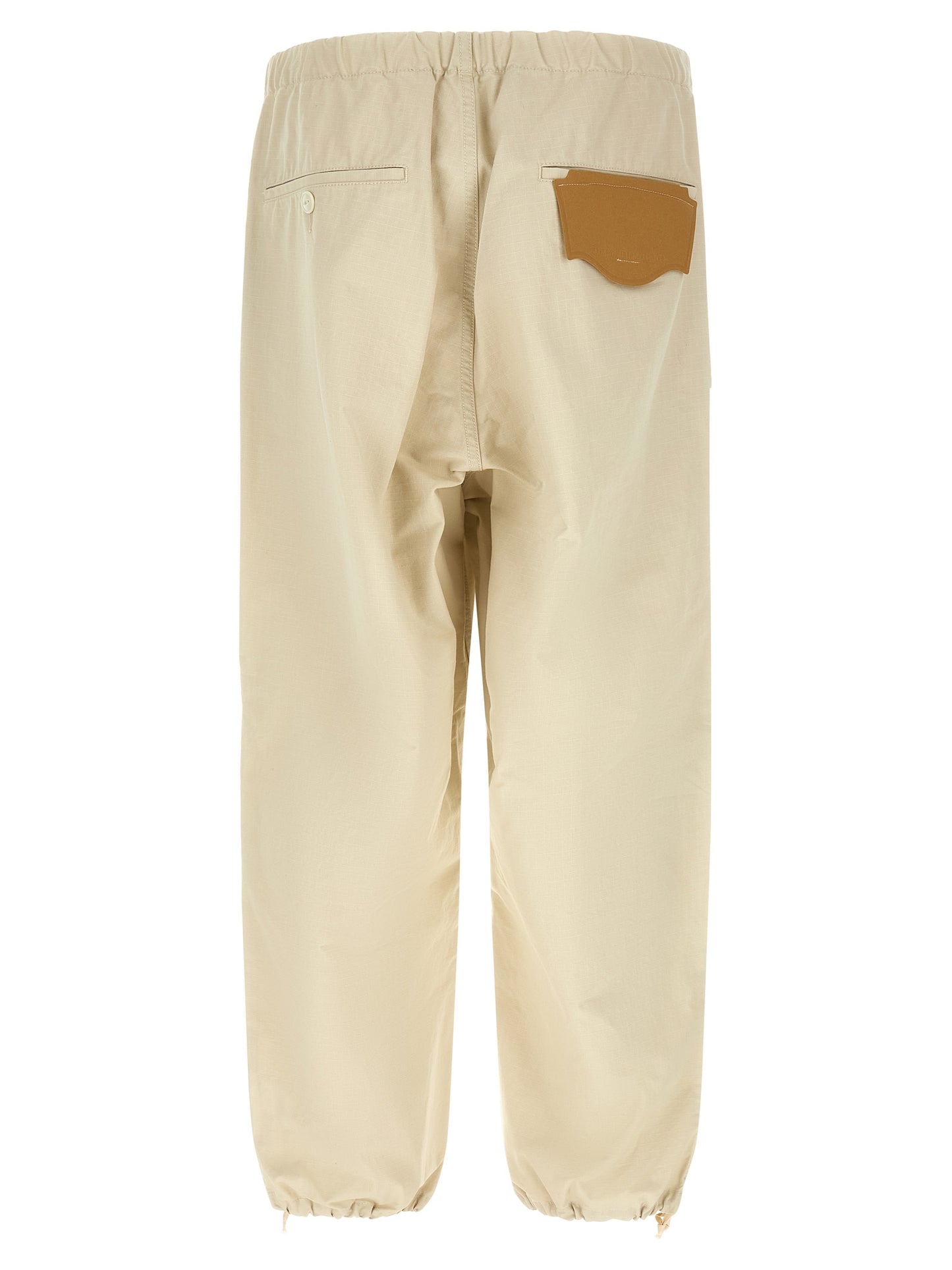 Activewear Pants by Maison Mihara Yasuhiro for men in cotton beige features an dynamic tapered-leg, athletic & wide with a long and , expertly finished with functional for a dynamic silhouette.