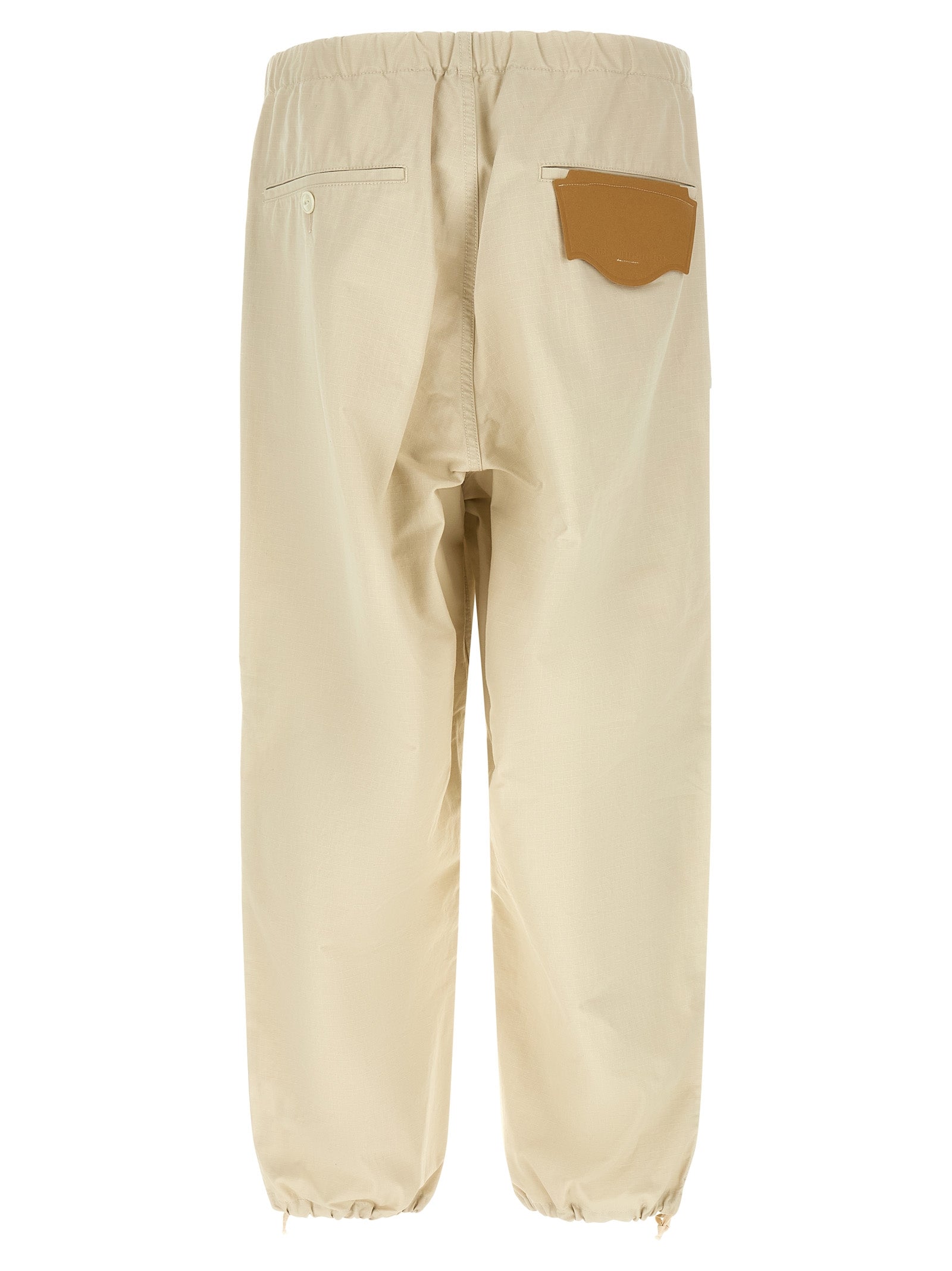 Activewear Pants by Maison Mihara Yasuhiro for men in cotton beige features an dynamic tapered-leg, athletic & wide with a long and , expertly finished with functional for a dynamic silhouette.