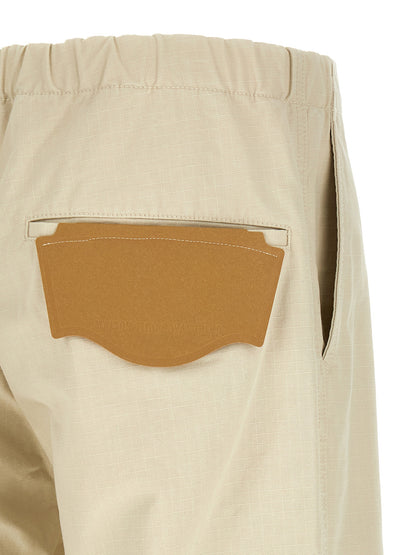 Activewear Pants by Maison Mihara Yasuhiro for men in cotton beige features a ergonomic tapered-leg, athletic & wide and with a ergonomic long, showcasing innovative for a ergonomic look.
