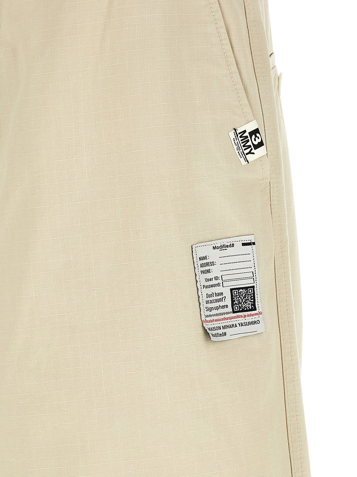 Activewear Pants by Maison Mihara Yasuhiro for men in cotton beige features an streamlined design with , highlighting a streamlined tapered-leg, athletic & wide and long cut with a comfortable .