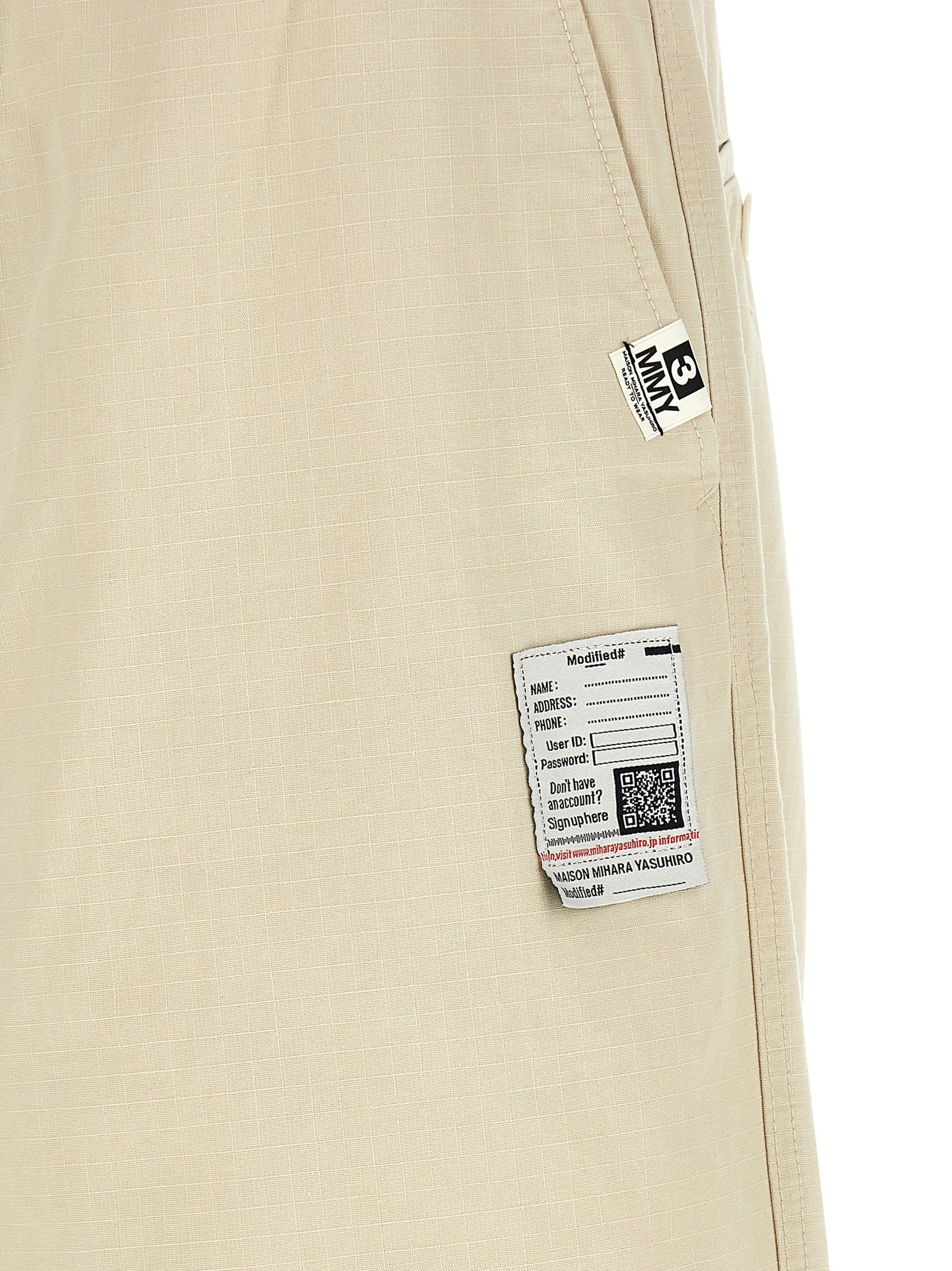 Activewear Pants by Maison Mihara Yasuhiro for men in cotton beige features an streamlined design with , highlighting a streamlined tapered-leg, athletic & wide and long cut with a comfortable .