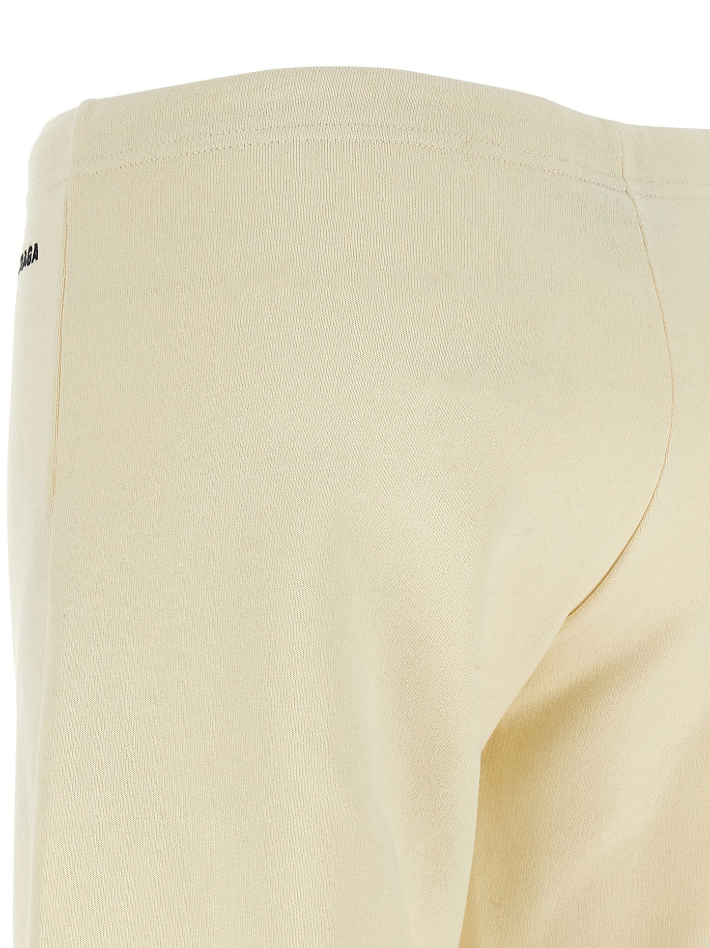 Joggers by Balenciaga for women in cotton white presents a tailored silhouette, showcasing a tailored flared & wide and long cut with a refined low rise for a truly tailored aesthetic.