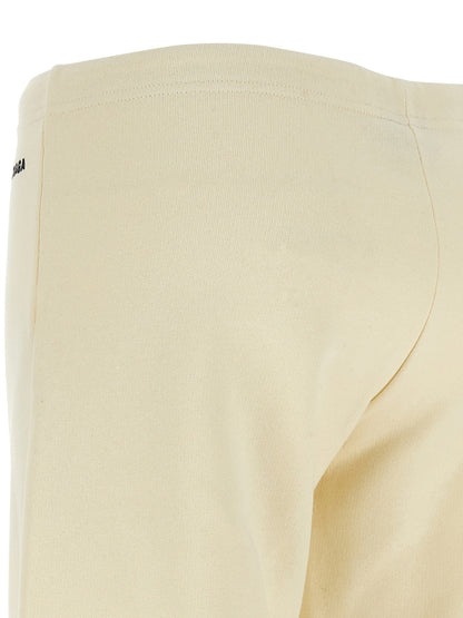 Joggers by Balenciaga for women in cotton white presents a tailored silhouette, showcasing a tailored flared & wide and long cut with a refined low rise for a truly tailored aesthetic.