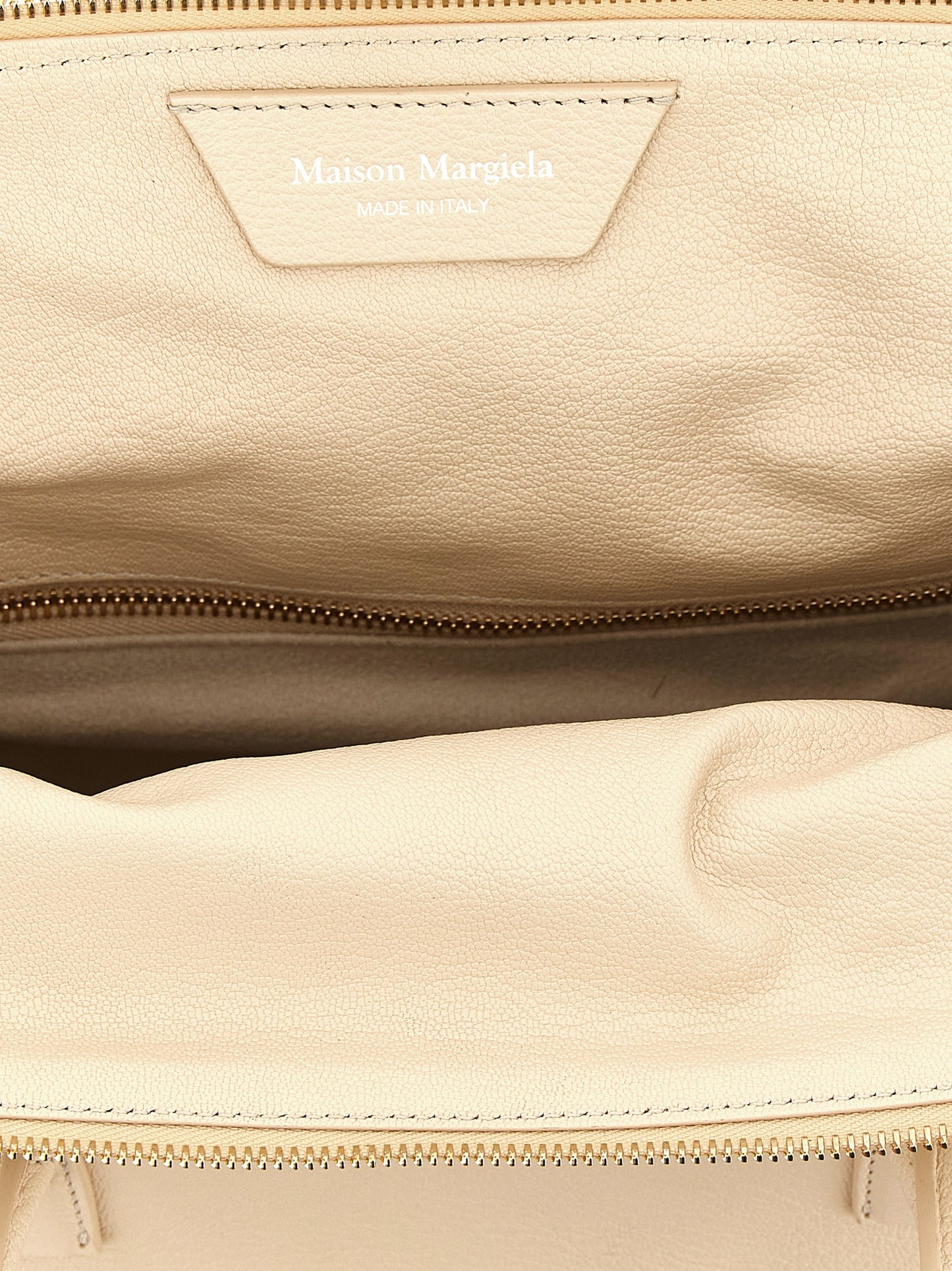 This East West Handbag by Maison Margiela for women in viscose goat leather & fur and multicolor, pink & signature presents a sculptural silhouette featuring a secure zipper, ample , and versatile shoulder-strap, adjustable-strap & handle for a sculptural finish.