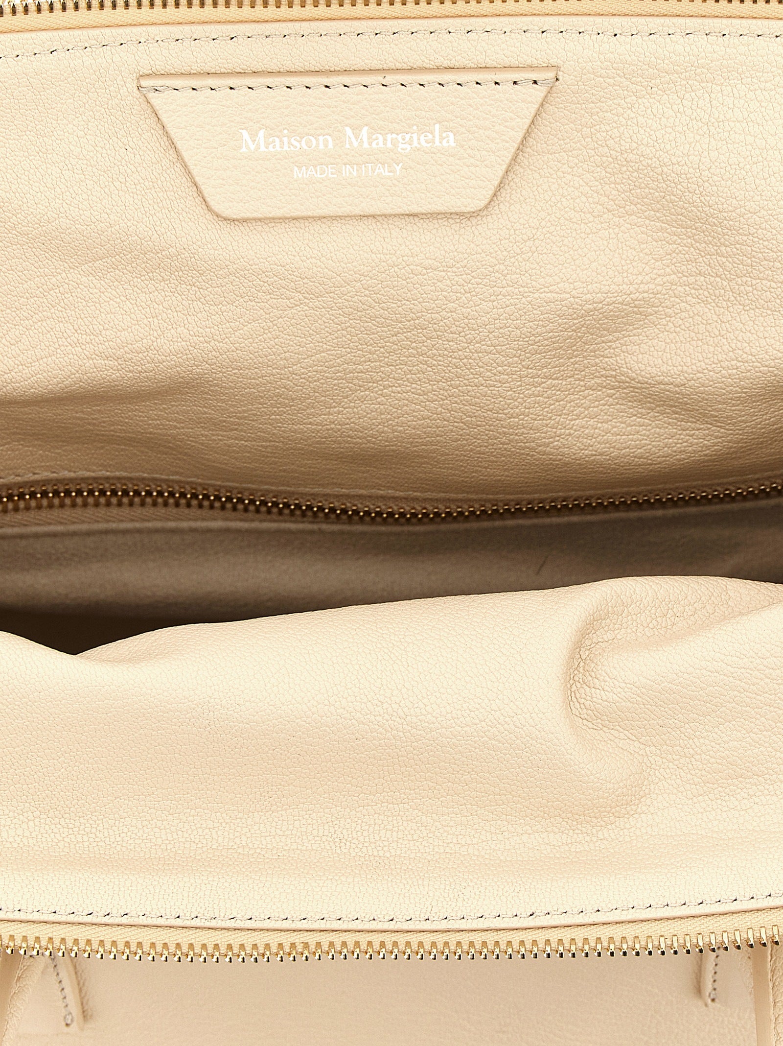 This East West Handbag by Maison Margiela for women in viscose goat leather & fur and multicolor, pink & signature presents a sculptural silhouette featuring a secure zipper, ample , and versatile shoulder-strap, adjustable-strap & handle for a sculptural finish.
