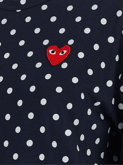 T-Shirt by Comme Des Garçons Play for women in cotton blue, red & print showcases a unassuming silhouette, artfully detailed with a refined and unassuming for a sophisticated, contemporary look.
