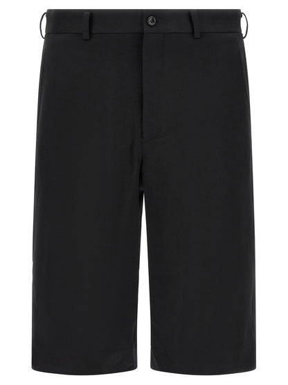 Bermuda Shorts by Comme Des Garçons for men in wool black presents a contemporary silhouette, showcasing a contemporary straight-leg, flared & wide with a refined short and elegant .