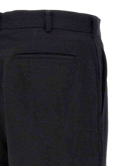 Bermuda Shorts by Comme Des Garçons for men in wool black presents a sleek silhouette, featuring a sleek straight-leg, flared & wide with a refined short and a sophisticated .