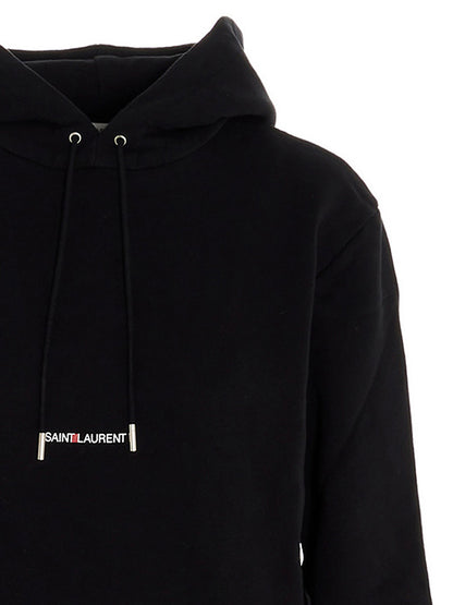Sweatshirt Hoodie by Saint Laurent for women in cotton black & print features a slouchy chic silhouette, detailed with a slouchy chic and a signature hooded neckline for an elevated aesthetic.