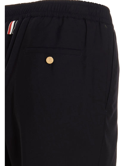 Trousers by Thom Browne for men in wool blue features a tailored silhouette with a tailored athletic, defined by its long and a sophisticated .