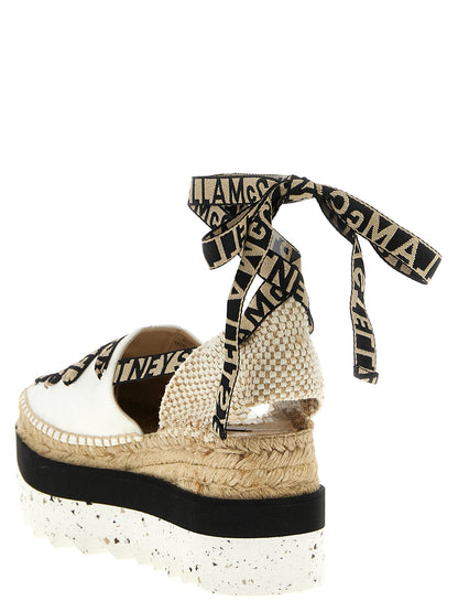 Wedge Sandals by Stella McCartney for women in cotton canvas & raffia beige features an exquisite silhouette, showcasing the exquisite Women's Cotton Canvas & Raffia Wedge Sandals with a wedge and .