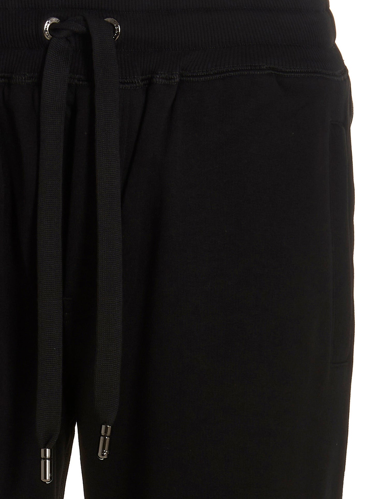 Joggers by Dolce & Gabbana for men in cotton black features a polished silhouette with a polished , reaching a polished long and finished with a polished .