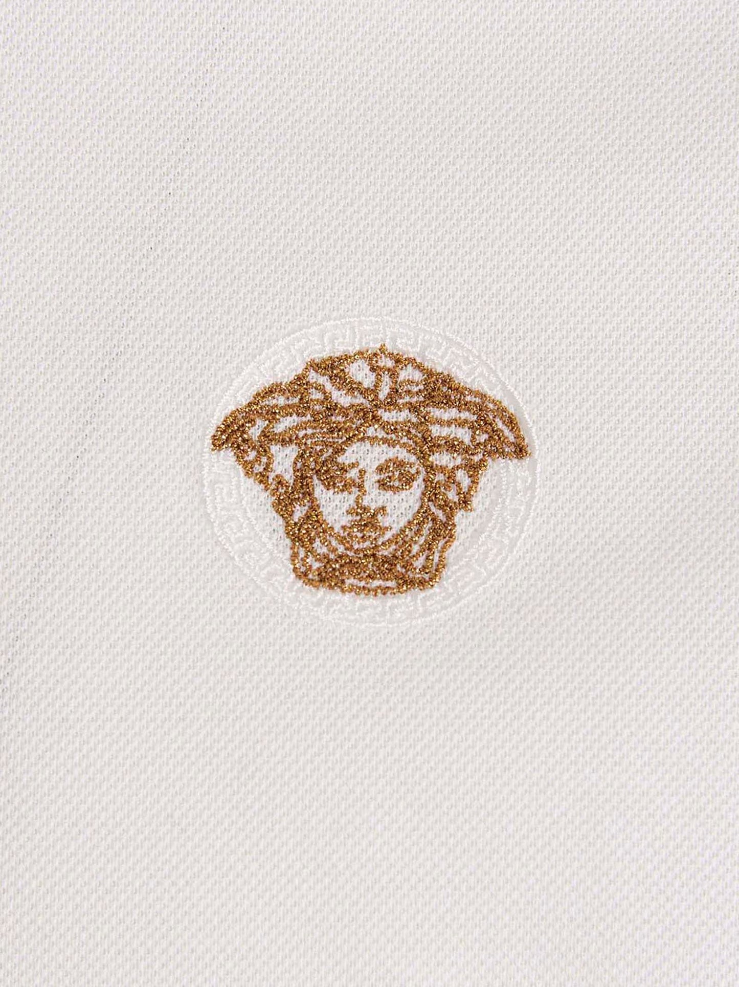 This Polo Shirt by Versace for men in cotton white & signature presents a flawless silhouette, showcasing flawless detailing and a refined for a truly flawless aesthetic.