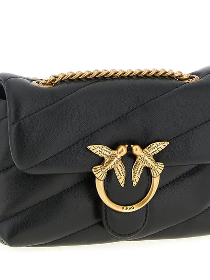 Large Crossbody Flap Handbag by PINKO for women in nappa & suede lamb leather black & signature features a multifaceted silhouette, showcasing a secure flap, magnetic & buckle and multifaceted with versatile crossbody-strap & shoulder-strap for multifaceted style.