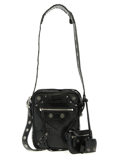 This Crossbody Messenger Clutch Bag by Balenciaga for men in polyester & lamb leather black presents a versatile silhouette from the Le Cagole Polyester & Lamb Leather Crossbody Messenger Clutch Bag collection, featuring a secure zipper, ample , and versatile crossbody-strap, shoulder-strap & adjustable-strap.