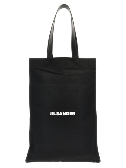 Large Shopper Tote Bag by Jil Sander for women in linen poly cotton canvas & leather black & print showcases a urban-chic Linen Poly Cotton Canvas & Leather Large Shopper Tote Bag design, featuring a secure , ample , and versatile handle for a urban-chic finish.