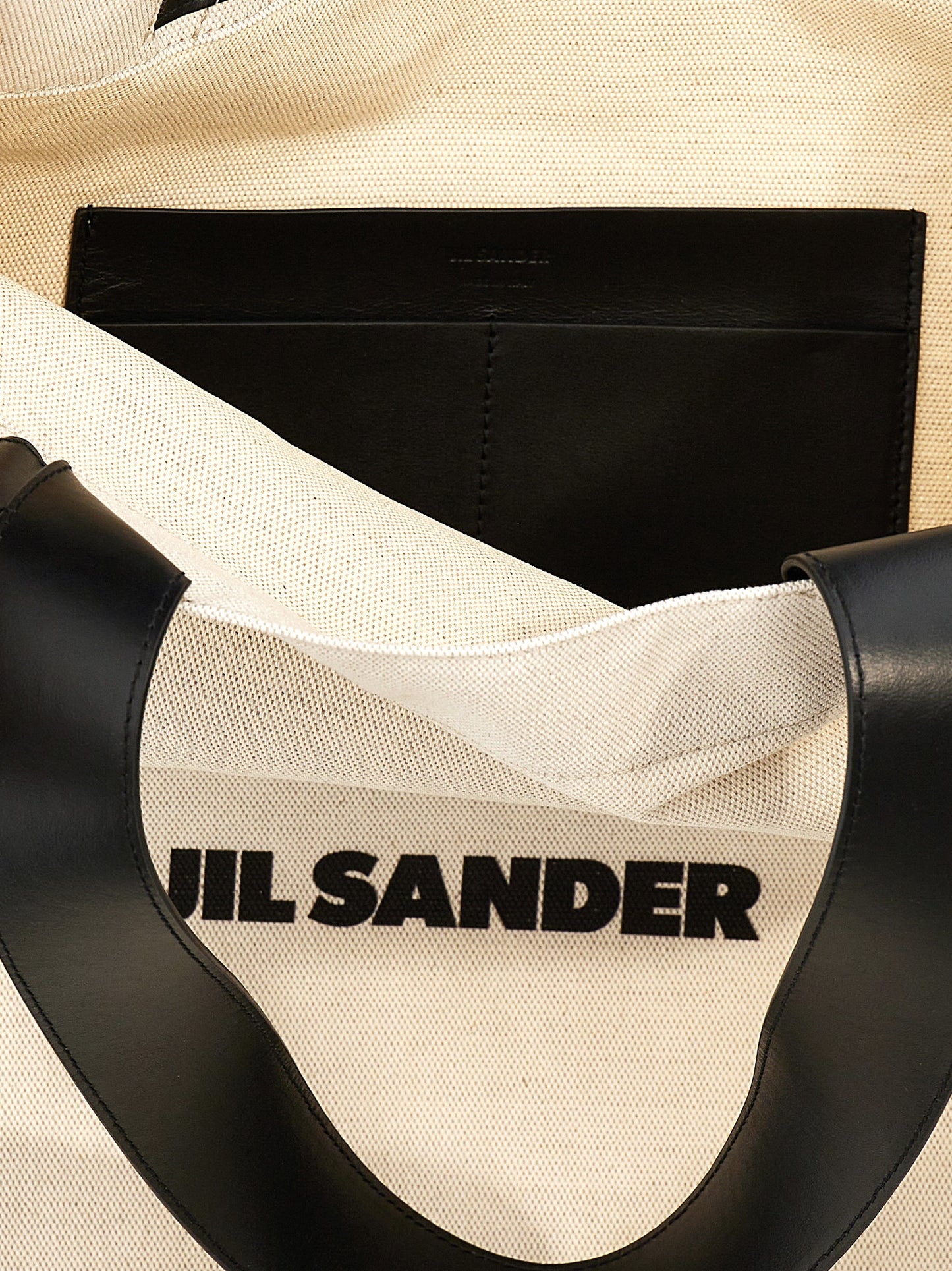 Large Shopper Tote Bag by Jil Sander for women in linen poly cotton canvas & leather bicolour, black, white & print features an utilitarian-chic silhouette, showcasing the City Linen Poly Cotton Canvas & Leather Large Shopper Tote Bag design with a secure , ample , and versatile handle.