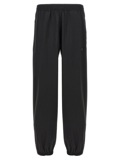 Trousers by Givenchy for men in virgin wool black features a sculptural silhouette, showcasing a sculptural and long with a sophisticated for a sculptural finish.