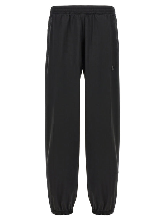 Trousers by Givenchy for men in virgin wool black features a sculptural silhouette, showcasing a sculptural and long with a sophisticated for a sculptural finish.