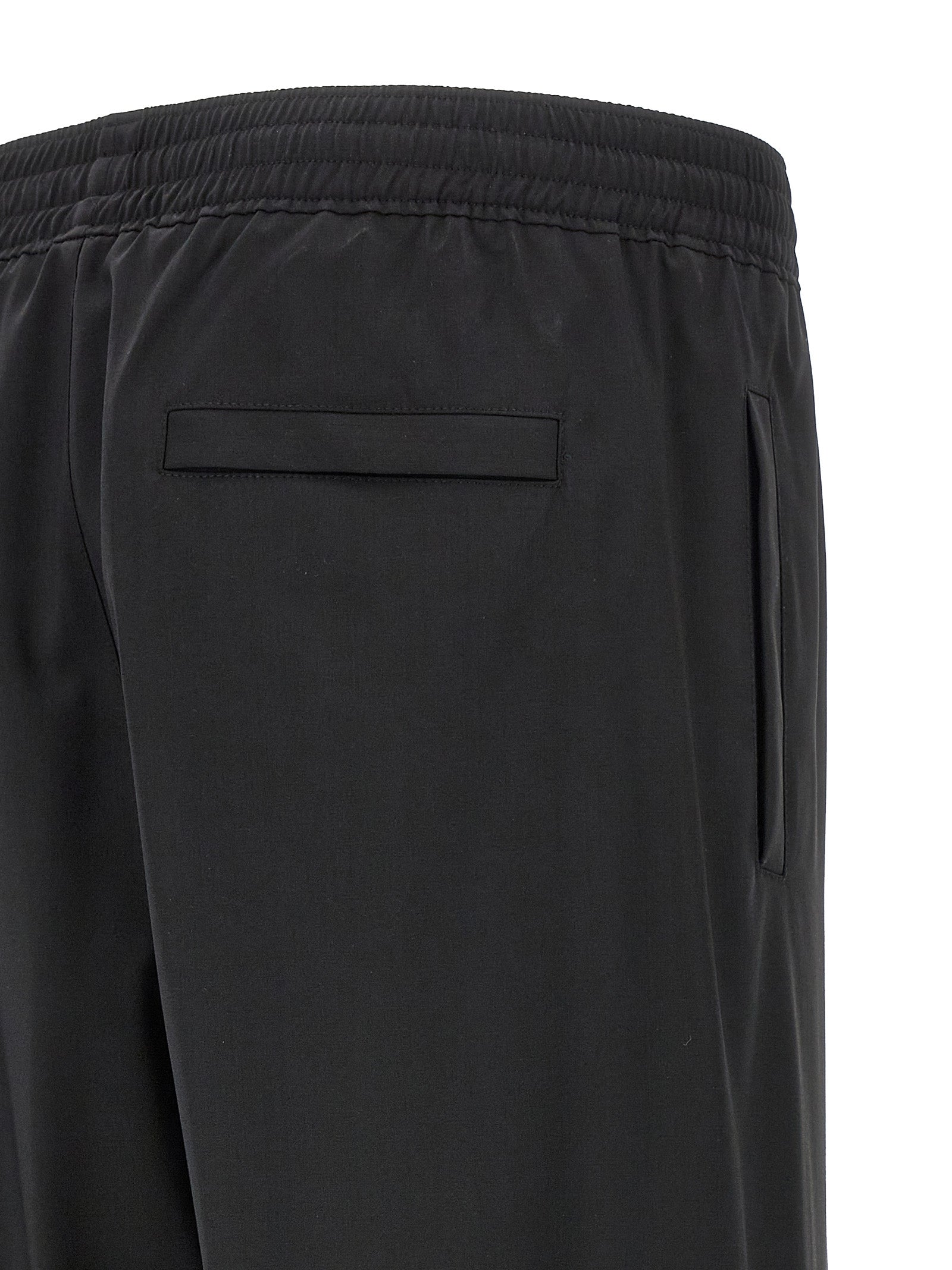 Trousers by Givenchy for men in virgin wool black features a artisanal silhouette, showcasing a sophisticated with a long and for a artisanal finish.