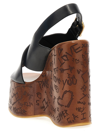 Platform Wedge Sandals by Chloé for women in cowhide leather black & natural presents a sculptural silhouette, showcasing the Women's Cowhide Leather Platform Wedge Sandals design with a sculptural platform wedge and for a premium look.