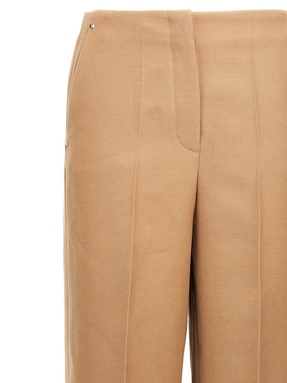 Trousers by Fendi for women in wool beige features a tailored silhouette with a tailored wide, defined by its long and a sophisticated .