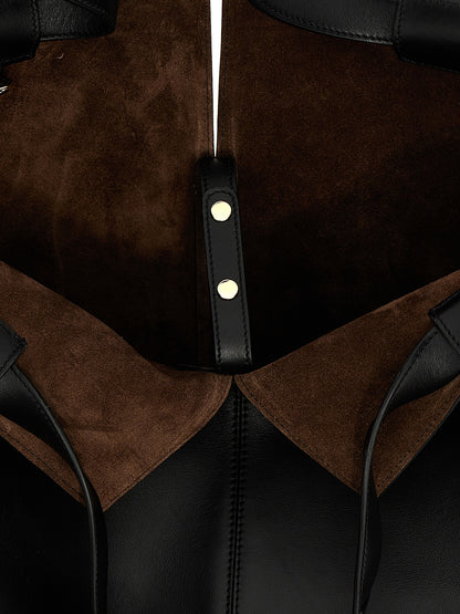 This Shopper Tote Clutch Bag by Tod's for women in suede calfskin leather black features an on trend Di Bag Folio Suede Calfskin Leather Shopper Tote Clutch design with a secure zipper, ample , and on trend handle.