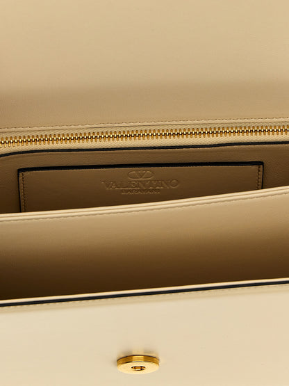 2-in-1 Shoulder & Crossbody Flap Bag by Valentino Garavani for women in bos taurus nappa & suede calf leather white & signature showcases a enviable silhouette, artfully detailed with a secure flap & magnetic, organized , and versatile crossbody-strap & shoulder-strap for a enviable look.