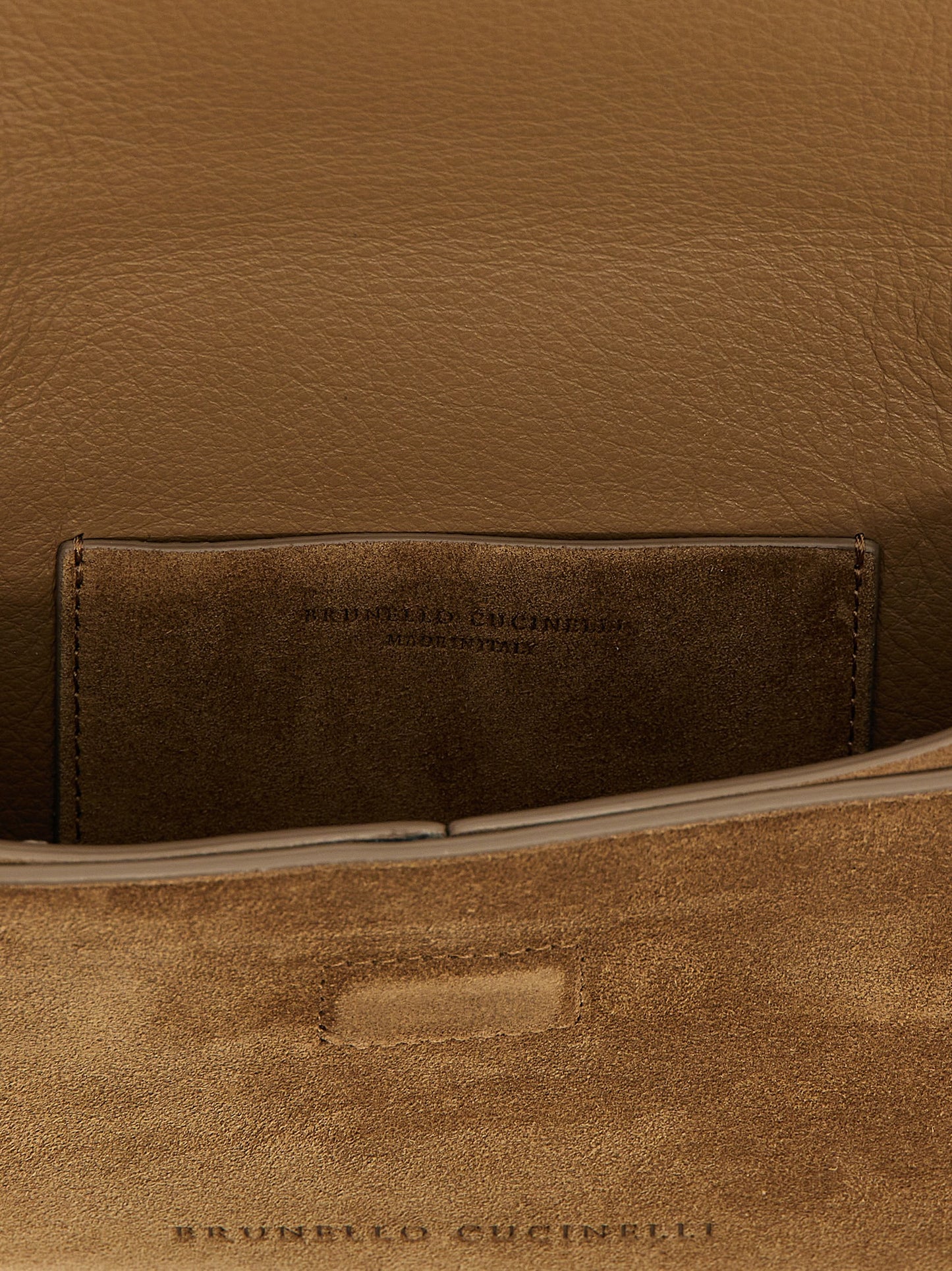 Evening Flap Clutch Handbag by Brunello Cucinelli for women in suede calfskin leather brown features a sculptural silhouette with a secure flap & magnetic, ample , and versatile shoulder-strap for a sculptural finish.