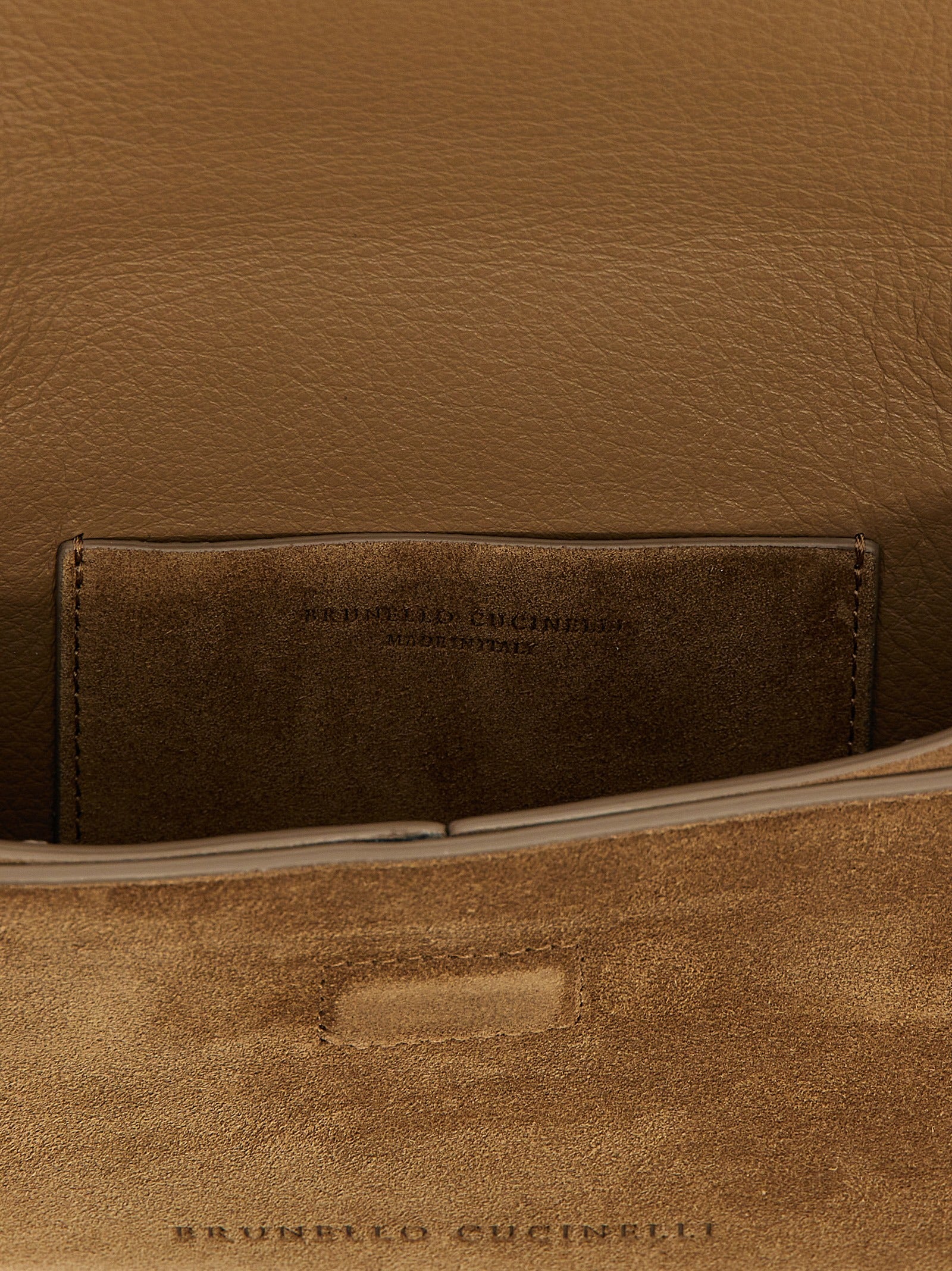 Evening Flap Clutch Handbag by Brunello Cucinelli for women in suede calfskin leather brown features a sculptural silhouette with a secure flap & magnetic, ample , and versatile shoulder-strap for a sculptural finish.