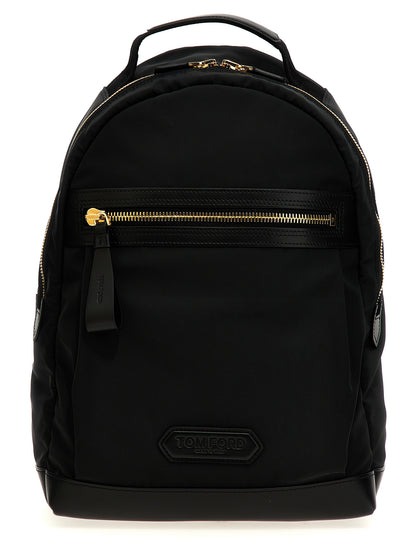 Travel Backpack by Tom Ford for men in calf leather & poly nylon black & signature features an ultra-portable silhouette from the Calf Leather & Poly Nylon Travel Backpack range, with a secure zipper, ample external-pockets, and versatile backpack-strap & adjustable-strap.