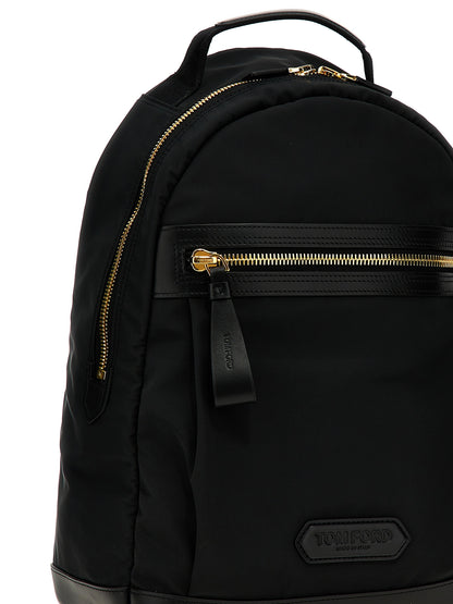 Travel Backpack by Tom Ford for men in calf leather & poly nylon black & signature features a utilitarian chic Calf Leather & Poly Nylon Travel Backpack design with a secure zipper, ample external-pockets, and versatile backpack-strap & adjustable-strap for a utilitarian chic finish.
