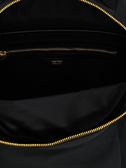 Travel Backpack by Tom Ford for men in calf leather & poly nylon black & signature features a utilitarian chic Calf Leather & Poly Nylon Travel Backpack design with a secure zipper, ample external-pockets, and versatile backpack-strap & adjustable-strap for a utilitarian chic finish.