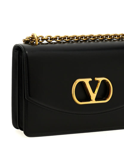 Shoulder Flap Bag by Valentino Garavani for women in calfskin leather black & signature features a effortless chic silhouette with a secure flap & magnetic, ample , and versatile shoulder-strap for a effortless chic finish.