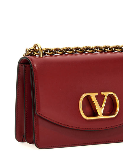 2-in-1 Shoulder & Crossbody Flap Bag by Valentino Garavani for women in calfskin leather multicolor, red & signature features an effortlessly chic silhouette with a secure flap & magnetic, ample , and versatile crossbody-strap & shoulder-strap for effortlessly chic everyday luxury.