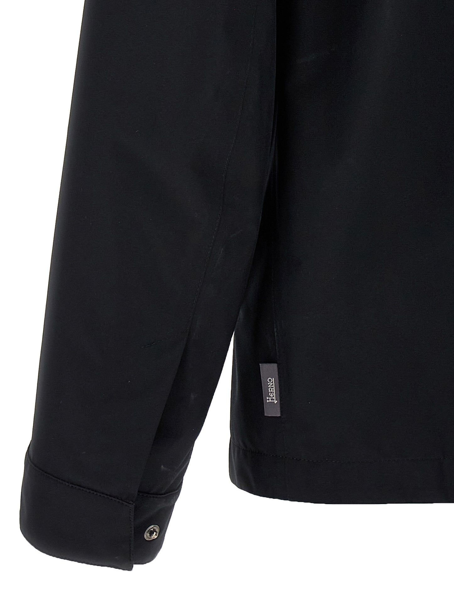 Windbreaker Jacket by Herno for men in polyester black presents a resilient silhouette, artfully detailed with a sophisticated and functional windproof & pockets for a resilient finish.