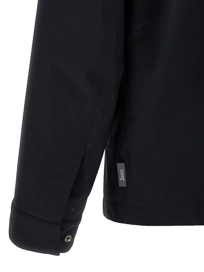 Windbreaker Jacket by Herno for men in polyester black presents a resilient silhouette, artfully detailed with a sophisticated and functional windproof & pockets for a resilient finish.