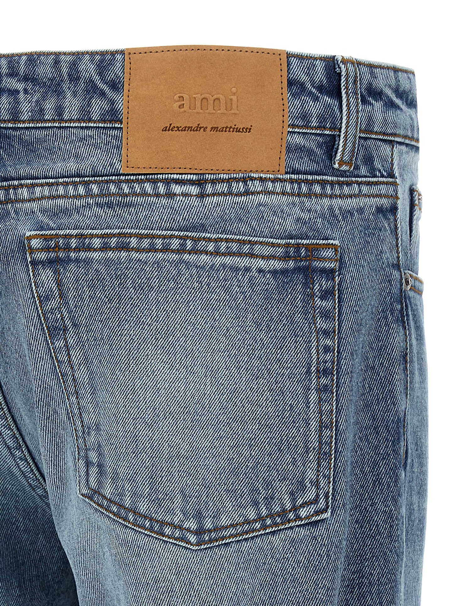 Jeans by Ami Paris for men in denim cotton blue & signature presents a tailored silhouette, showcasing a tailored straight-leg and long cut with a refined for a truly tailored aesthetic.