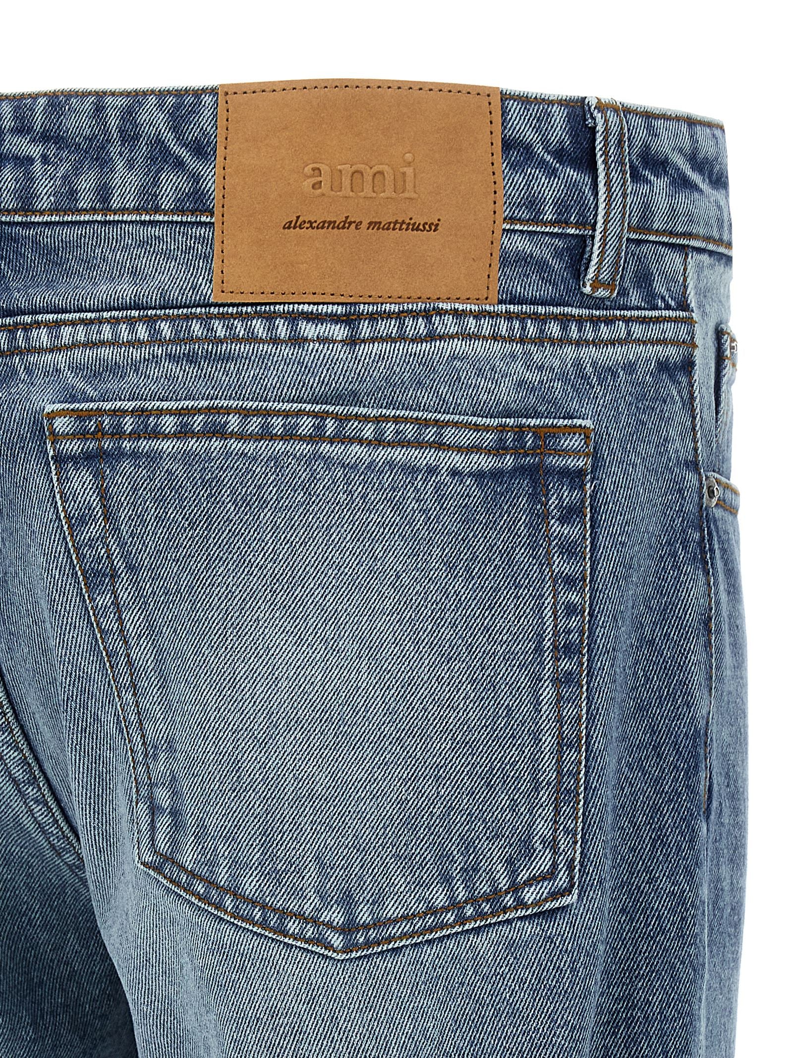 Jeans by Ami Paris for men in denim cotton blue & signature presents a tailored silhouette, showcasing a tailored straight-leg and long cut with a refined for a truly tailored aesthetic.