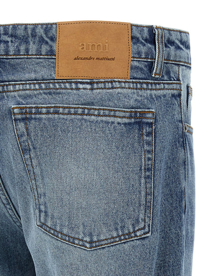 Jeans by Ami Paris for men in denim cotton blue & signature presents a tailored silhouette, showcasing a tailored straight-leg and long cut with a refined for a truly tailored aesthetic.
