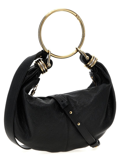 This Hobo Handbag by Chloé for women in calfskin leather and black presents a sculptural silhouette featuring a secure zipper, ample , and versatile shoulder-strap, adjustable-strap, detachable-strap & handle for a sculptural finish.