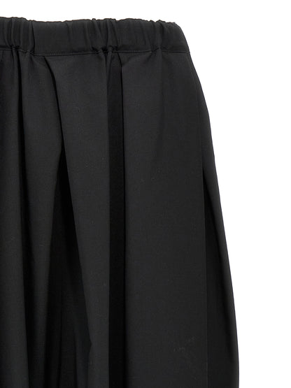Skirt by Comme Des Garçons for women in wool black features a captivating silhouette, showcasing the captivating Women's Wool Skirt design with a sophisticated midi for a captivating look.