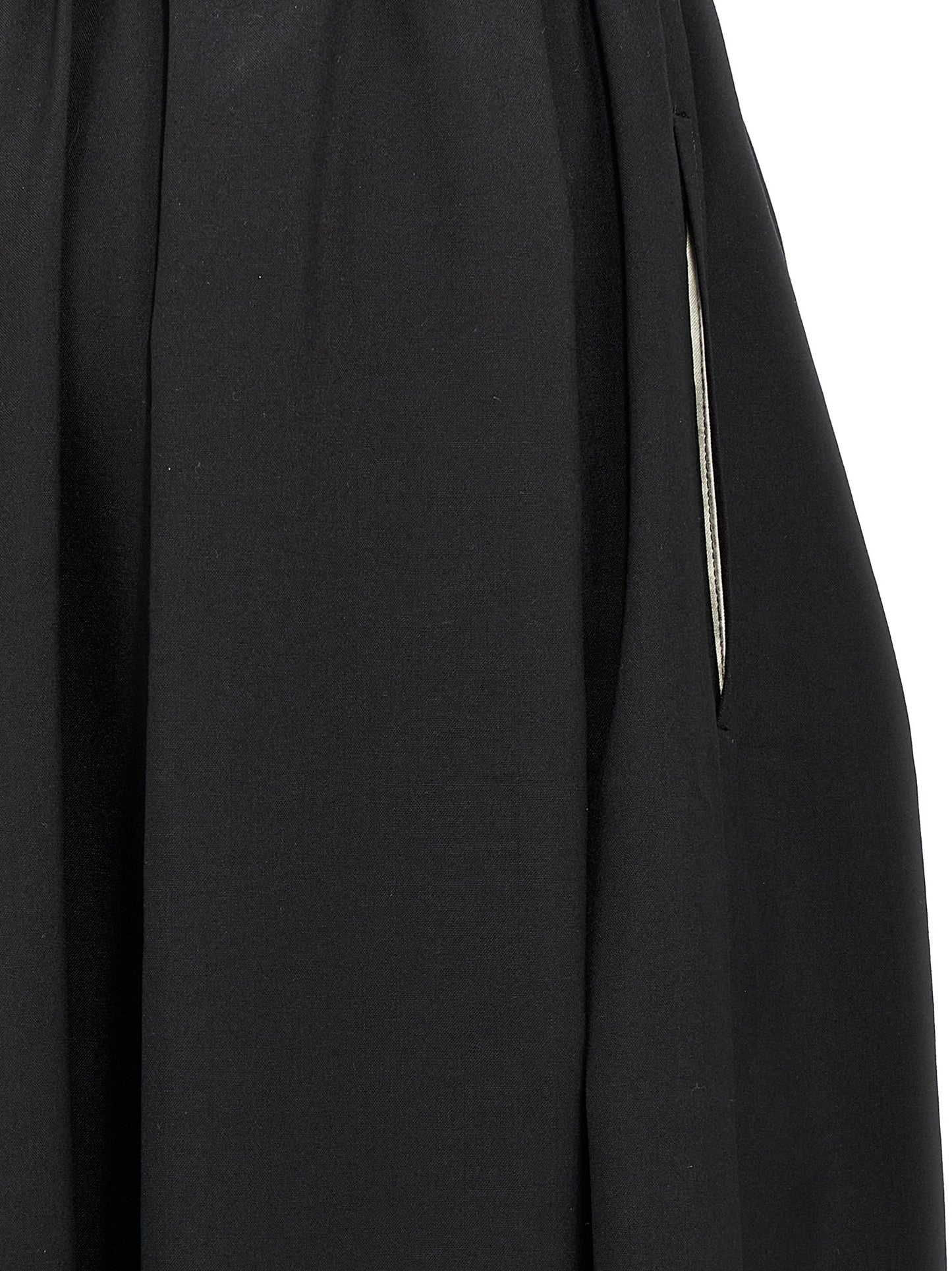 Skirt by Comme Des Garçons for women in wool black features an tailored silhouette, artfully capturing the essence of Women's Wool Skirt in a sophisticated midi.