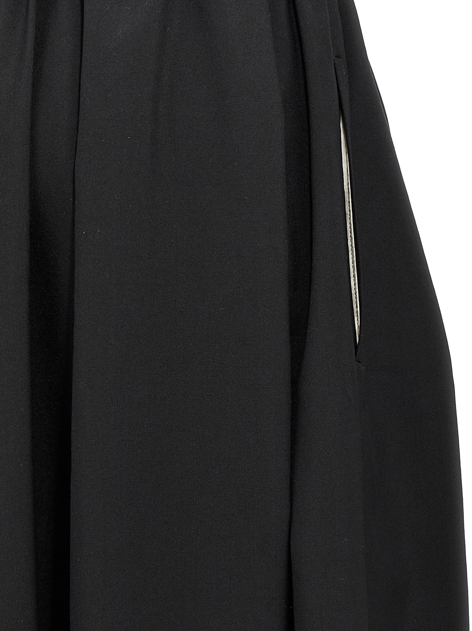 Skirt by Comme Des Garçons for women in wool black features an tailored silhouette, artfully capturing the essence of Women's Wool Skirt in a sophisticated midi.