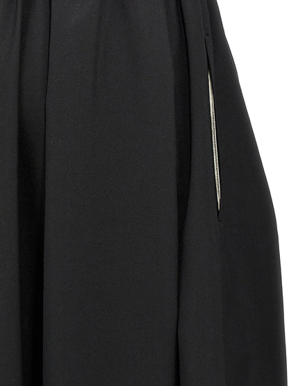 Skirt by Comme Des Garçons for women in wool black features an tailored silhouette, artfully capturing the essence of Women's Wool Skirt in a sophisticated midi.