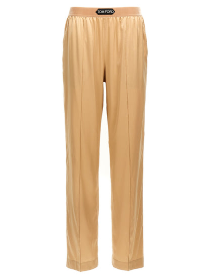 Trousers by Tom Ford for women in silk velvet beige presents a perennial silhouette, meticulously tailored with a straight-leg cut, long finish, and an elegant .