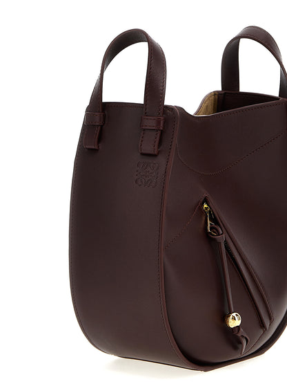 Crossbody Handbag by Loewe for women in calfskin leather bordeaux features a transformative elegance silhouette, showcasing a secure zipper & magnetic, organized , and versatile crossbody-strap, shoulder-strap & adjustable-strap for a transformative elegance look.