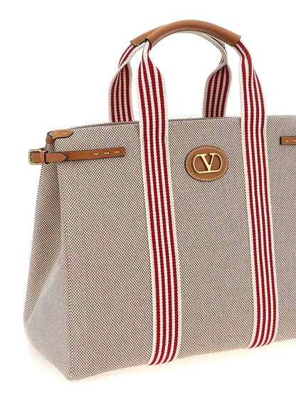 Handbag by Valentino Garavani for unisex in cotton & leather multicolor & signature presents a ornamental silhouette, showcasing a secure magnetic, ample , and versatile adjustable-strap & handle for a ornamental finish.