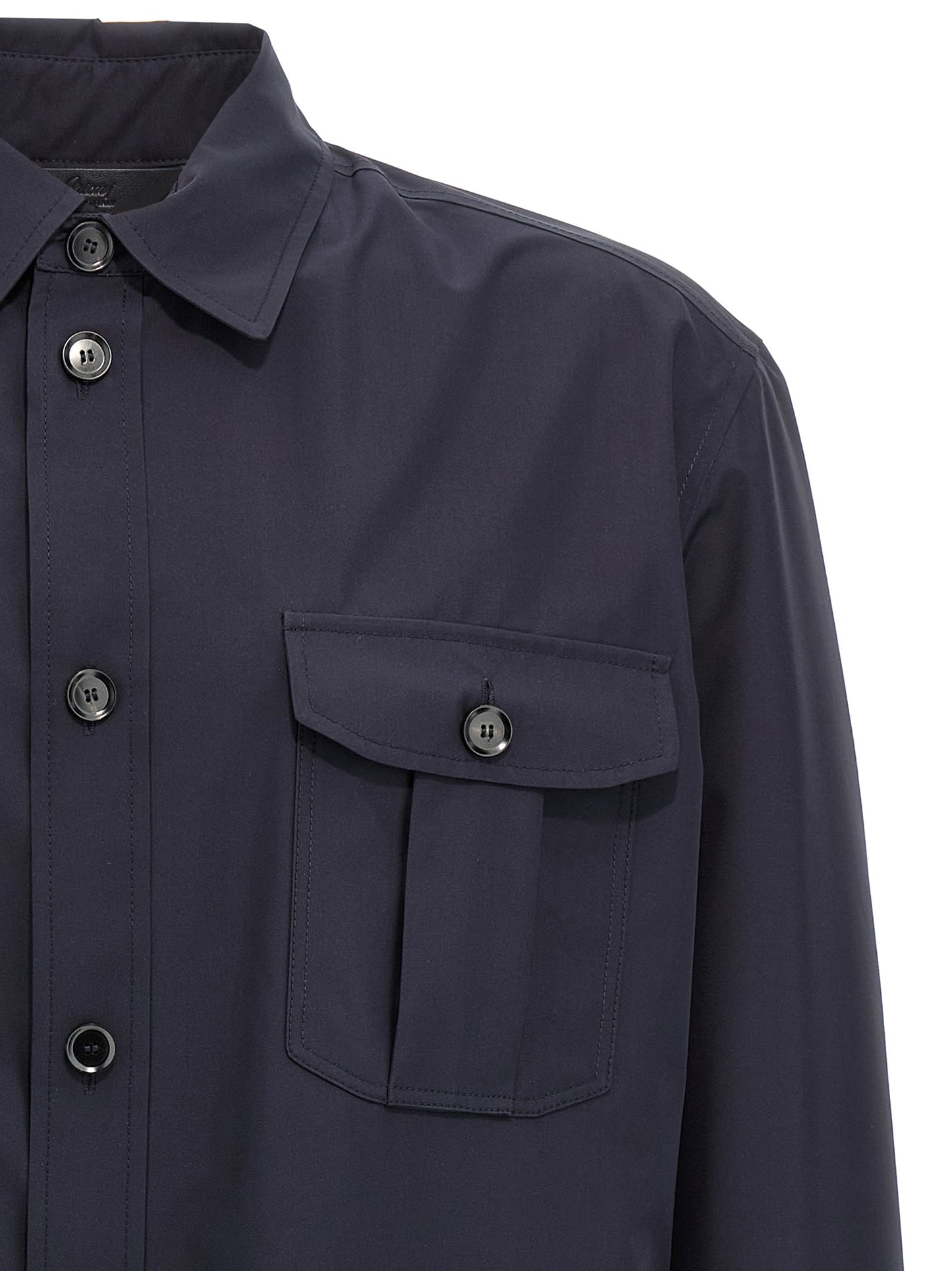Jacket by Brioni for men in silk blue features an utilitarian silhouette with a refined wrap shirt-collar neckline, showcasing sophisticated pockets for an utilitarian aesthetic.